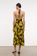 Back view floral halter dress with open back and pink lacing; yellow daisies on black.