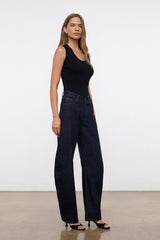 Indigo barrel-leg jeans worn by model, front three-quarter view