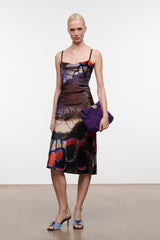 Silk midi dress with spaghetti straps, draped cowl neckline, butterfly print; purple clutch