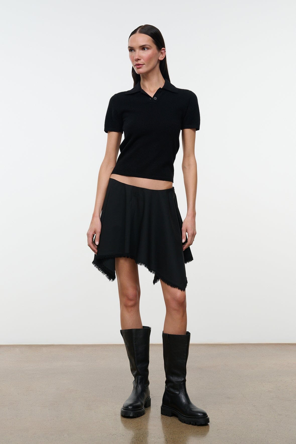 Black short skirt with draped front and uneven frayed hem