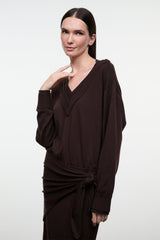 Dark oak knit sweater dress with V-neck and long sleeves, waist tie at front