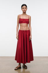 Red midi skirt with gathered waistband and flowy pleated skirt