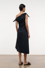 Black one-shoulder midi dress, back view, tied shoulder bow and gathered waist