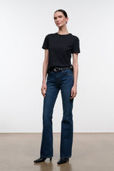Dark indigo flare jeans with belt loops, button-zip front, and straight-to-flare legs
