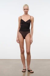 Dark brown ruched one-piece swimsuit worn model with thin spaghetti straps
