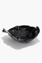 Black glazed wavy ceramic bowl, glossy irregular rim