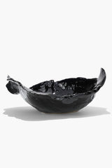 Black glossy wavy ceramic bowl with asymmetrical fluted edges