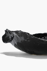 Black glazed wavy ceramic bowl with glossy wavy surface