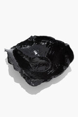 Black glazed wavy ceramic bowl with raised wavy sides and reflective finish