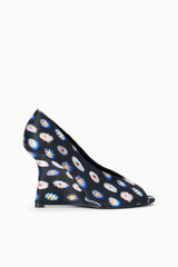 Side view of peep-toe wedge heel with dark floral print fabric upper