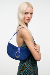 Cobalt crescent suede shoulder bag with side strap and silver ring clasp