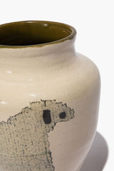 Ceramic vase close-up showing black sheep face silhouette on beige speckled glaze