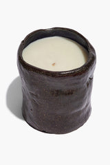 Dark speckled ceramic candle with open top and white wax insert