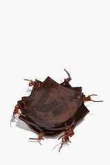 Square ceramic coaster set with burnt sienna speckled glaze and rustic cord ties