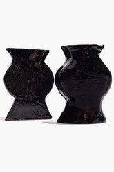Black glossy ceramic vase bookends, front view of two angled vases
