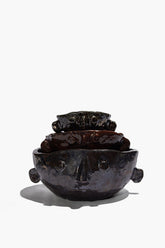 Stacked Large Henry bowls in dark glaze, showing sculpted faces and side knobs.
