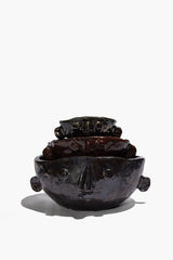 Stacked Large Henry bowls in dark glaze, showing sculpted faces and side knobs.