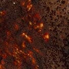 Medium Henry bowl glaze close-up, dark bronze speckled with orange highlights.