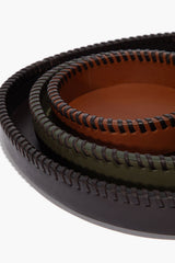Close-up of round leather tray rims with layered edge and contrast stitching