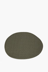 Oval moss green leather placemat with woven grid texture