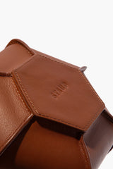 Tan leather bottle vase, stitched front panel detail with embossed HOLLIS
