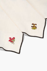Natural embroidered napkins with black-trimmed edges and red flower corner embroidery
