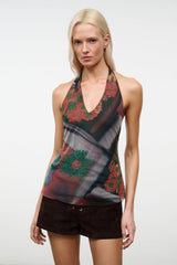 Close-up sleeveless beaded V-neck top with dark floral pattern and sheer beaded details