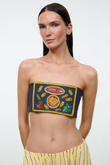 Front close-up of navy strapless tube top with colorful embroidered patch and yellow trim