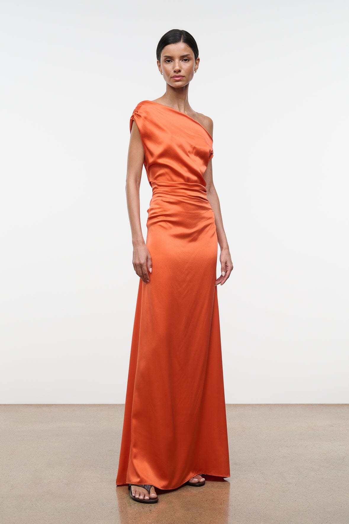 Orange silk one-shoulder maxi dress with side ruching and draped bodice