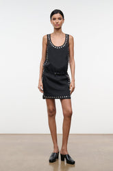 Black sleeveless mini dress with stud-studded neckline and side detailing