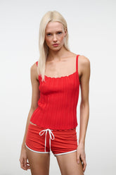 Tomato ribbed tank top with scalloped trim and ruched texture, close-up front