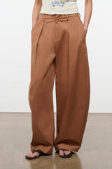 Carob brown wide-leg pants with front pleats, belt loops, and relaxed fit