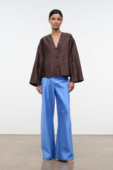 Light blue silk dupioni wide-leg pants with smooth drape and gathered waist