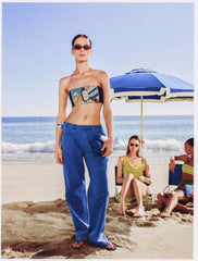 Strapless tube top with colorful graphic patch on navy, worn with blue pants