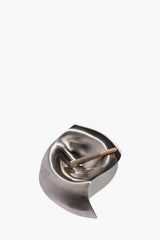 Silver metal ashtray with cigarette rest slot and pointed base