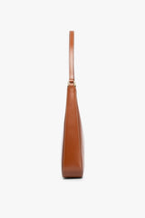 Tan leather-look hobo bag with top handle, side view