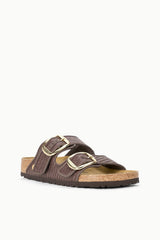 BIRKENSTOCK Arizona slide sandals, side view, dark raffia straps and metal buckles