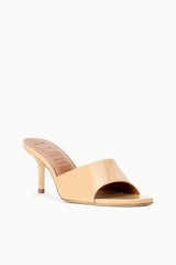 Tan patent leather open-toe mule slide with high stiletto heel, side view