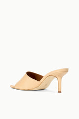 Tan patent leather mule slide with open toe and high stiletto heel, side view