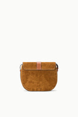 Tan suede saddle bag with center flap and small side handles, crossbody strap.