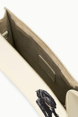 Cream shoulder bag interior with dark lining and stitched pocket