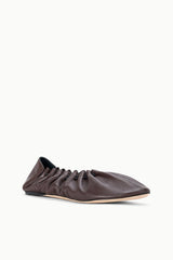 Espresso-brown flat shoe, side view showing ruched upper and stitching