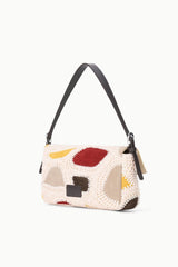 Patchwork suede shoulder bag with woven body, adjustable strap, and side zip pocket