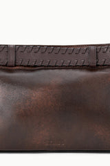 Espresso-brown leather shoulder bag close-up of stitched front band.