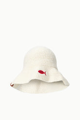 Crochet bucket hat in off-white with red fish applique and short brown side tag.