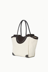 Two-tone tote bag angled view with dark top handles and cream canvas sides