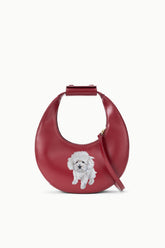Maroon mini moon bag with top handle, side strap, and custom dog face patch