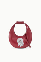 Maroon mini moon bag with top handle, side strap, and custom dog face patch