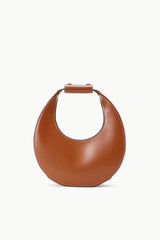 Mini moon bag tan leather with crescent shape and top handle.