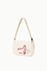 Cream tweed shoulder bag with red “ssshh” figure graphic and “STAY” text